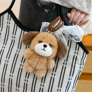 Adorable sad pouty dog plush keychain with lace bow accessory for handbags and keys