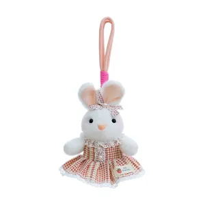 Adorable white plush rabbit keychain wearing a checkered dress with lace trim details