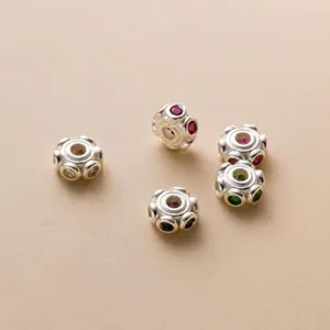 Detailed macro view of S925 sterling silver spacer beads with colorful stones