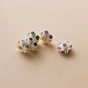 Macro detail of S925 sterling silver spacer beads with colorful stones for DIY jewelry