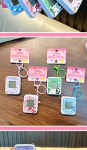 Detailed view of electronic pet machine keychains with colorful matching game consoles