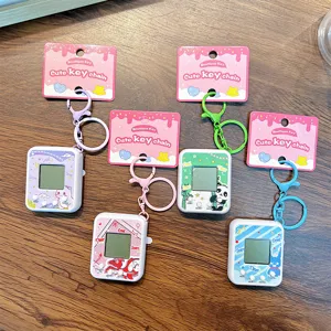Set of 5 cute virtual pet electronic game machine keychains on wooden background
