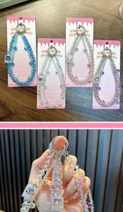 Close-up of crystal beaded phone straps with miniature perfume bottle charms.