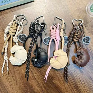 Faux leather croissant bag charms with braided ropes and heart-shaped clips in four colors