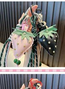 Detailed view of leather strawberry keychains with studs and woven ropes for bags