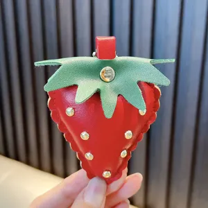 Unique handmade red leather strawberry keychain with green leaves and gold studs