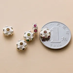 Close-up of 6mm S925 sterling silver beads with colored stones for size comparison