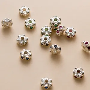 Detailed macro view of 6mm S925 sterling silver flat beads set with vibrant colorful stones