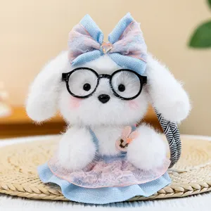 Cute white plush puppy keychain wearing glasses and a blue lace dress
