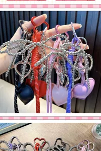 Hand holding colorful PU leather heart keychains with silver beaded bow detail charms