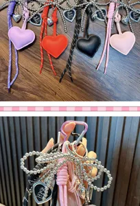 Detailed view of colorful PU leather heart keychains with silver ball chains.