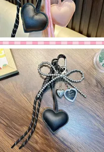 Close-up of PU leather heart keychain with beaded bow and photo frame charm