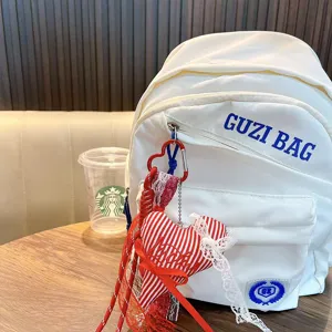 White backpack with red white striped heart pendant lace tassel, stylish daily casual bag.