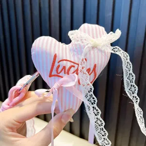 Pink striped heart plush bag charm with white lace and ribbon bow, cute handbag pendant.