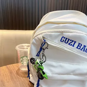 White school backpack with stylish motorcycle keychain pendant casual daypack for men women