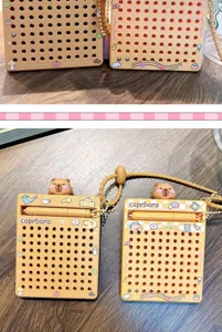 Detailed view of the orange Capybara magnetic bead drawing board with stylus and keychain