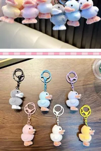 Set of colorful flocked duck keychains with plush texture and cute cartoon mascot design