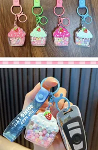 Macro view of liquid-filled cupcake keychain with colorful beads and sequins detail