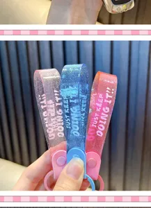 Glitter PVC wristlet keychain straps in pink blue and red with motivational text