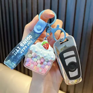 Adorable pastel cupcake liquid keychain featuring glittery blue strap and colorful jelly beans