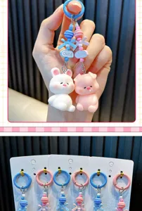 Close-up of cute pig and bunny keychains with colorful beads and cute lettering