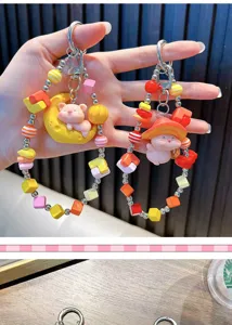 Close-up of cute pig figurines on colorful beaded phone straps and keychains