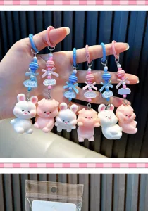 Detail view showing a variety of cute pig and rabbit keychains with beads and bows