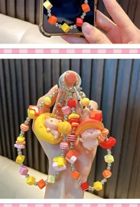 Detailed macro view of vibrant beaded phone charms with cute pig character decorations