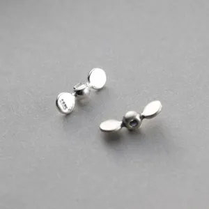 Close-up detail of 925 sterling silver retro propeller beads for DIY jewelry making