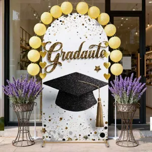 Graduation ceremony arch backdrop with mortarboard cap and Graduate lettering