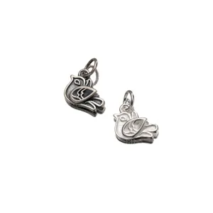 Close-up detail of S925 sterling silver retro bird pendants with a distressed finish