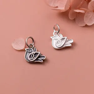 Macro view of vintage and bright S925 silver bird charms with intricate details
