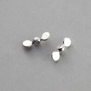 Detailed macro shot of vintage 925 sterling silver propeller-shaped spacer beads
