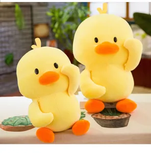 Detailed view of two cute yellow duck plush dolls with soft texture in a warm room