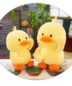 Pair of cute yellow duck plush toys sitting on books in a cozy indoor lifestyle scene.