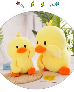 Detailed macro view of two sizes of cute yellow duck plush toy pillows on a mat