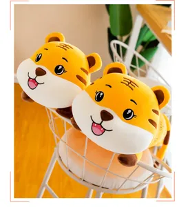 Two cute yellow tiger plush toys resting in a white wire basket in a home setting