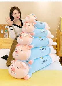 Detailed view of stacked sleeping pig plush pillows in various sizes