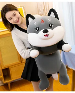 Close-up of a large cute husky plush body pillow being held in a cozy home setting