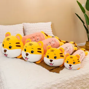 Set of four cute yellow tiger plush bolster pillows in different sizes on a cozy bed