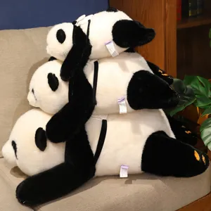Three realistic panda plush backpack toys in different sizes stacked on a cozy sofa