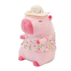 Pink capybara plush toy in swimsuit and sun hat with pineapple pattern