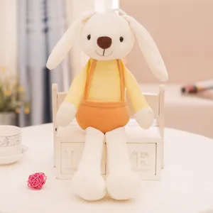 Cute white plush rabbit toy wearing a yellow striped shirt and orange overalls