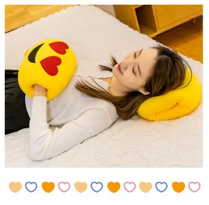 Cozy yellow emoji heart-eyes nap pillow featuring a convenient hand-insert design for warmth