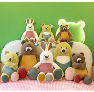 A group of colorful plush forest animals including fox bear and rabbit on a sofa