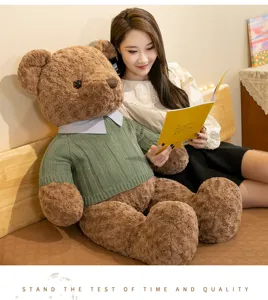Grande orsetto di peluche marrone con maglione verde, morbida bambola regalo per bambini.