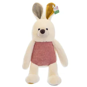 Cream white bunny rabbit plush toy wearing a pink knitted sweater and mixed color ears