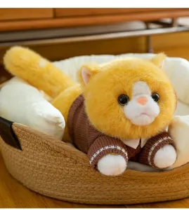 Close-up view of a cute plush ginger cat wearing a brown sweater in a cozy basket
