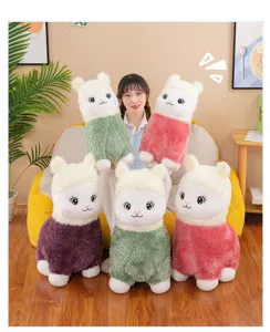 Soft colorful alpaca plush toys shown with a model in a cozy living room setting.