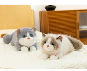 Realistic grey and beige ragdoll cat plushies on a soft white knit blanket